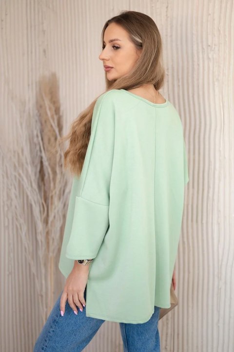 Bluzka oversize z wisiorkiem Masełko pistacjowa Bluzka oversize z wisiorkiem Masełko pistacjowa