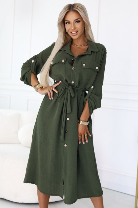 Kobieta w khaki szmizjerce midi z wiązaniem w talii i złotymi guzikami, modna stylizacja casual Kobieta w khaki szmizjerce midi z wiązaniem w talii i złotymi guzikami, modna stylizacja casual