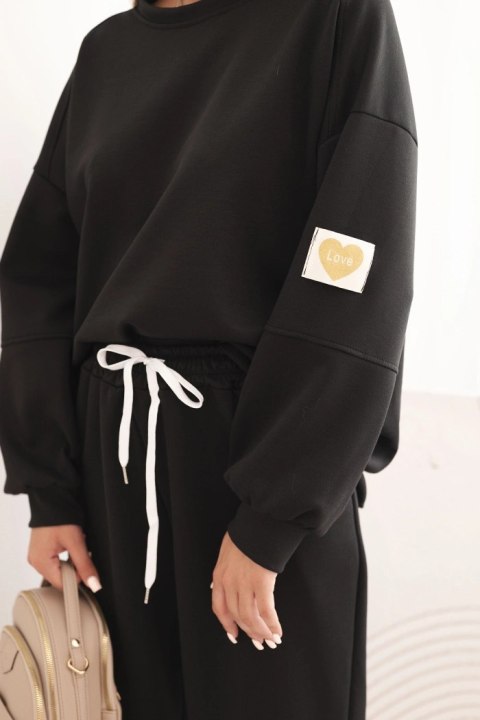 Czarna bluza oversize i spodnie damskie z troczkiem