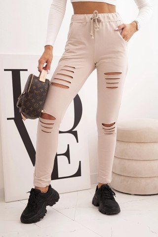 Beżowe bawełniane spodnie damskie z przetarciami i gumką w pasie