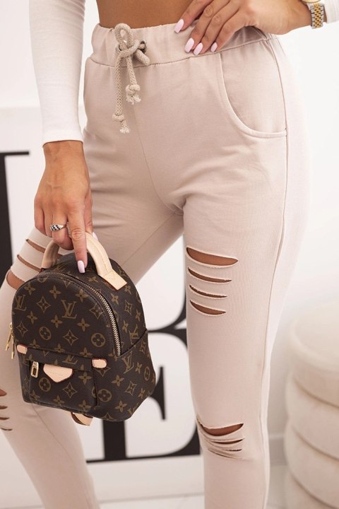 Spodnie damskie streetwear z przetarciami – kolor beżowy