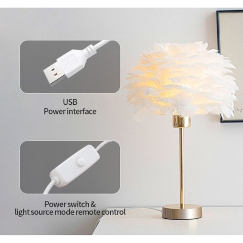 Lampka nocna glamour z białymi piórami ustawiona na komodzie
