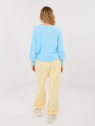 Pastelowe żółte spodnie dresowe damskie joggery ITALY MODA z broszką